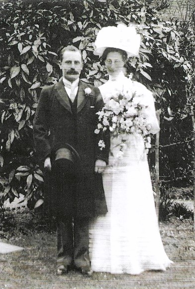 Edwardian wedding dress and hat worn by the bride, Margaret Tatchell, shown here with husband, John Lewis